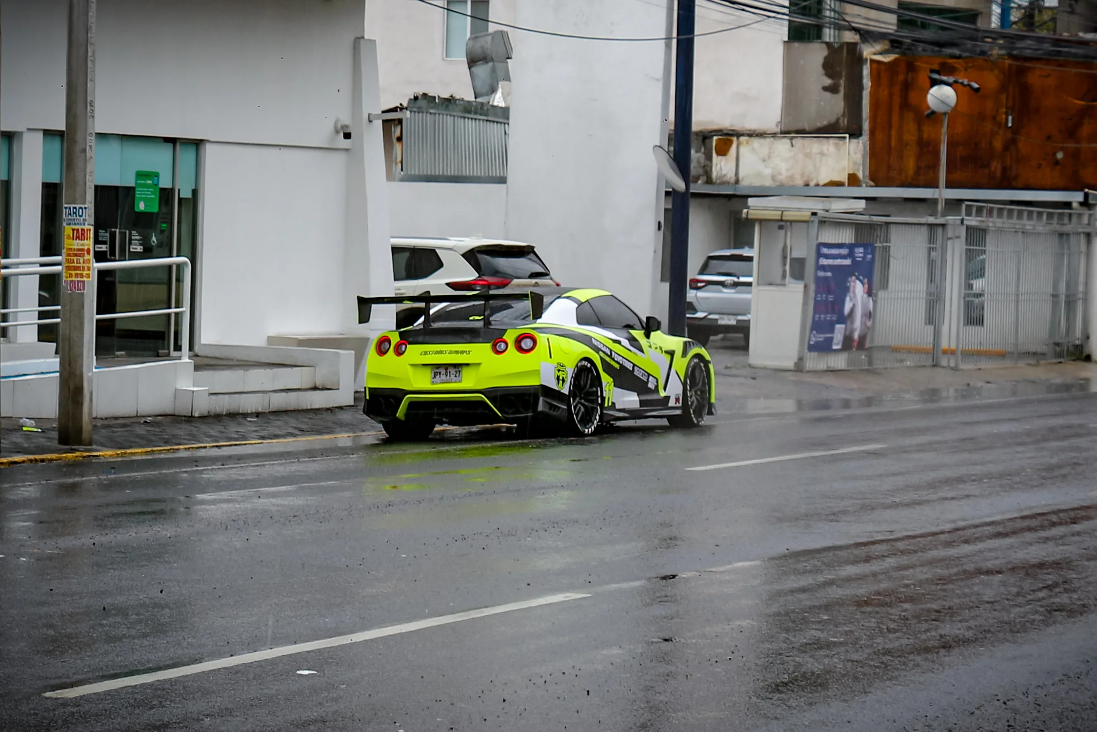 El GT-R de tres cuartos trasero, con las calcomanías de los patrocinadores y el número 11